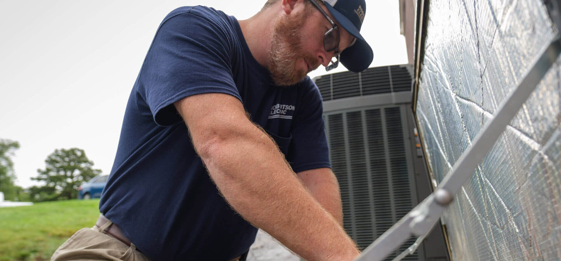 A Robertson Electric technician servicing a home generator - Robertson Electric A Robertson Electric technician servicing a home generator